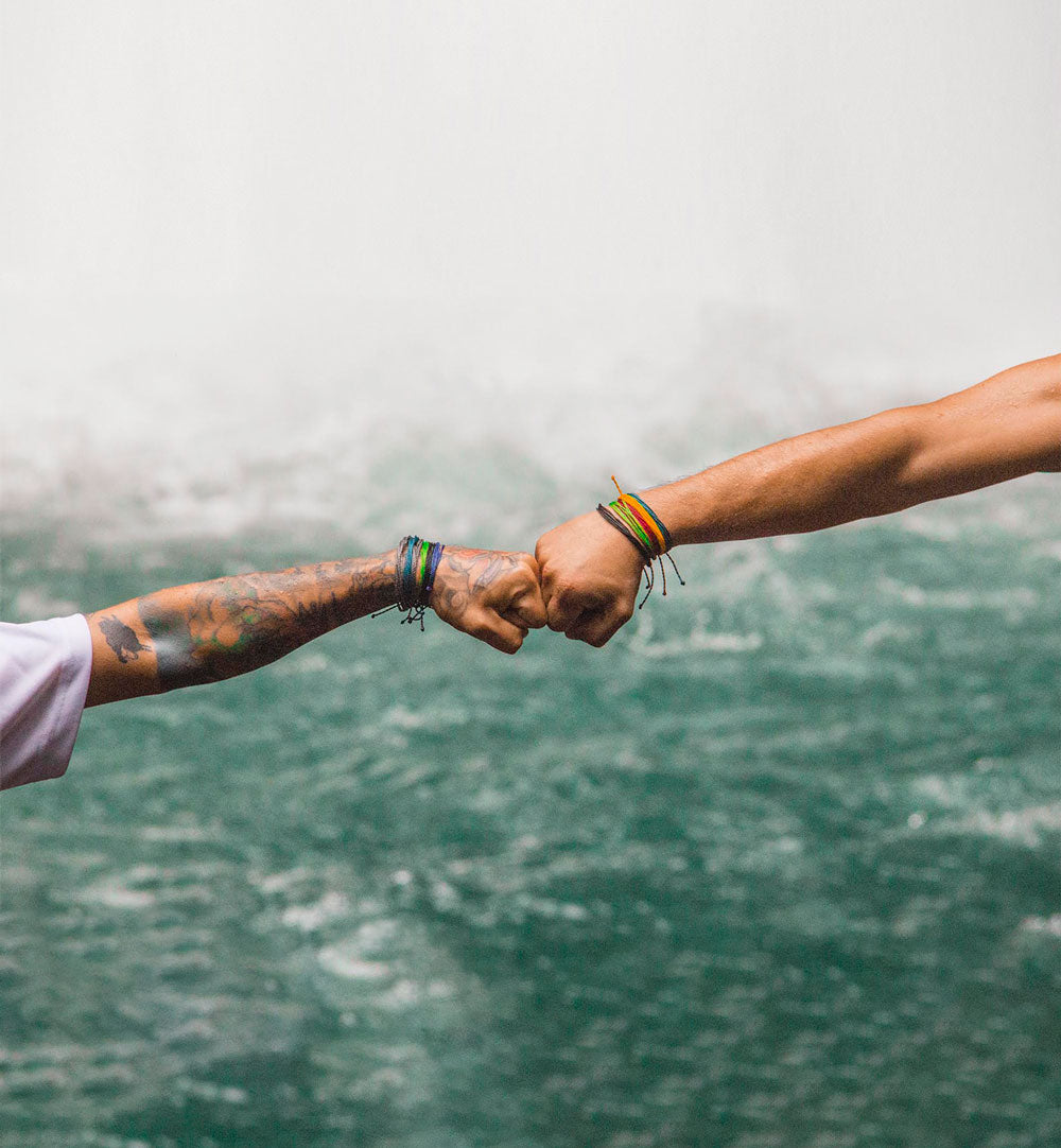 Two artisans pounding fists